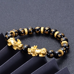Detail of 10mm black onyx beads with golden Pixiu and engraved mantra symbols