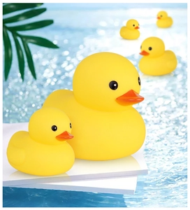 Detail of yellow rubber duck family floating on water for baby bath time fun