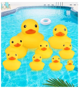 Family set of nine yellow rubber ducks floating in a blue swimming pool water