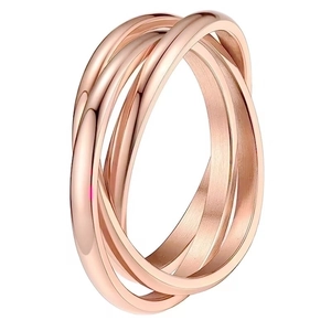 Macro shot of interlocking rose gold spinner rings in high-polish titanium steel finish