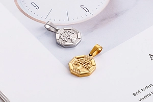 Detailed close-up of octagonal Tree of Life pendants in gold and silver finishes