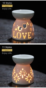 Macro detail of white ceramic oil burner with LOVE heart cutout and warm candlelight glow