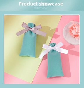 Detail view of velvet jewelry gift pouches with elegant satin bows on stone display