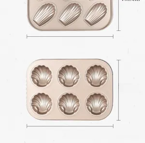 Detail view of 6-cavity Madeleine baking pans in champagne gold carbon steel