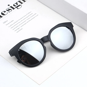 Close-up of kids matte black sunglasses featuring silver reflective mirror lenses