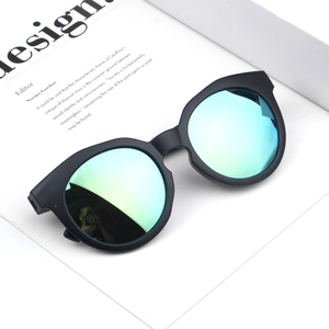 Detailed close-up of matte black frames and yellow-green gradient reflective lenses
