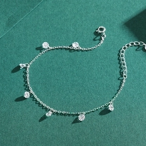 Sparkling S925 sterling silver bracelet with round zircon pendants on green background