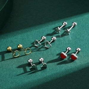 Minimalist S925 silver heart and star screw-back stud earrings on a textured green surface
