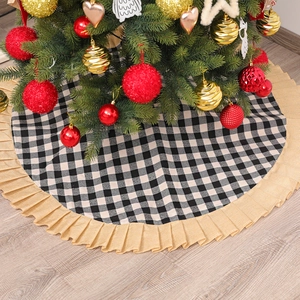 Classic red and black plaid Christmas tree skirt with linen ruffle edges on wood floor
