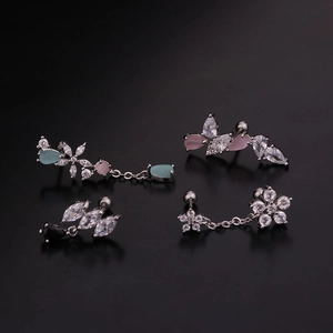 Detailed macro of flower and leaf stud earrings with colorful teardrop zircons
