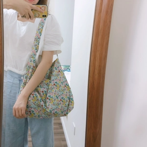 Floral print cotton tote bag shown on shoulder for a casual minimalist aesthetic