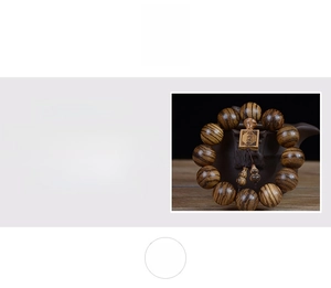 Close-up of Vietnamese agarwood beads with natural oil grain and engraved square pendant