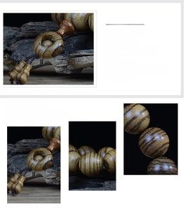 Detailed close-up of handmade natural wood 108-bead Buddhist bracelet with visible grain