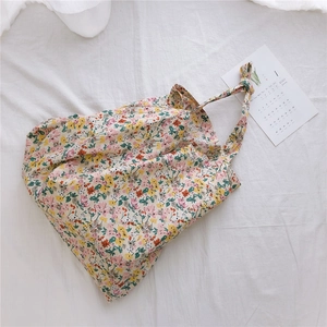 Close-up of floral cotton tote bag featuring knotted strap details and pastel patterns