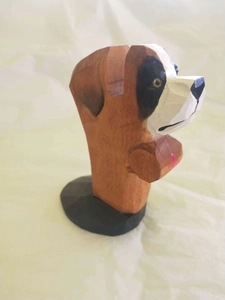 Detail of hand-carved wooden dog eyeglass holder with rustic brown and black finish