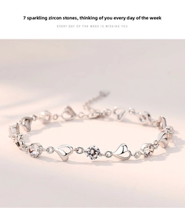 Close-up of 925 sterling silver heart bracelet featuring seven sparkling zircon stones
