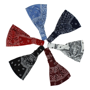 Close-up of six boho elastic headbands featuring classic paisley prints in various colors