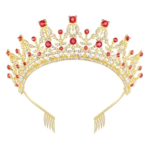 Close-up of golden crown with red rhinestones and side combs for secure hair styling