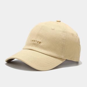 Close-up of beige cotton twill baseball cap featuring detailed CRUISE letter embroidery