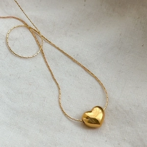 Polished 3D gold heart pendant on sleek chain, minimalist titanium steel necklace