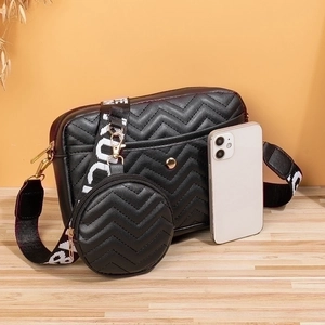 Black chevron quilted crossbody camera bag set with a small round pouch and wide strap