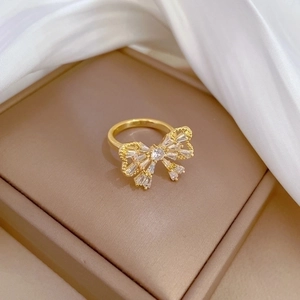 Luxurious gold butterfly zircon ring shown in a premium brown gift box on white silk