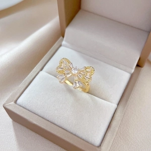 Luxurious gold butterfly zircon ring with sparkling crystals on elegant fabric