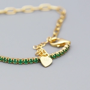 Elegant S925 silver gold bracelet with green zircon stones and heart charm detail