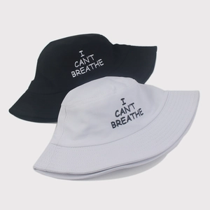 Black and white cotton bucket hats with I Can't Breathe embroidery on plain background