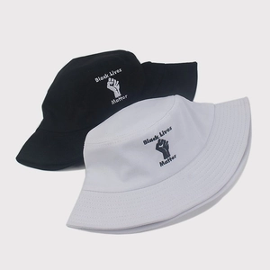 Detail view of cotton bucket hats with Black Lives Matter embroidery in black and white