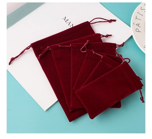 Multiple sizes of burgundy velvet drawstring gift pouches for jewelry storage and packing