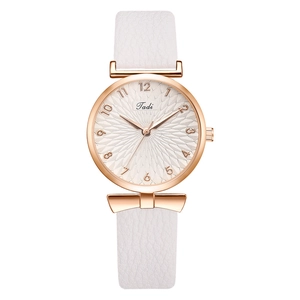 Détail du bracelet en cuir blanc avec boucle en or rose sur montre à quartz