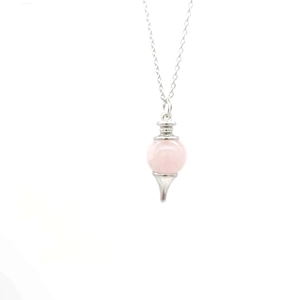 Detail of rose quartz pendulum necklace featuring a pink crystal sphere and silver cone base