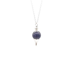 Detail of blue natural stone pendulum necklace with silver chain and ornate metal accents