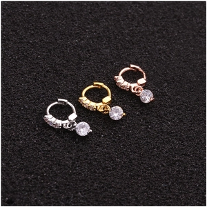 Three zirconia-encrusted small hoop earrings in silver, gold, and rose gold finishes