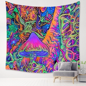 Detail of psychedelic mushroom tapestry with space elements hanging over a gray sofa