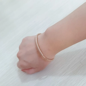 Polished 18K rose gold stainless steel open bypass bangle with sleek double ball ends