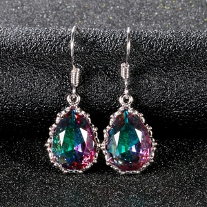 Close-up of vintage teardrop earrings with multi-color crystal and silver hooks