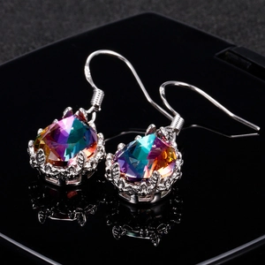 Classic vintage silver drop earrings featuring rainbow pear-cut crystals on black background