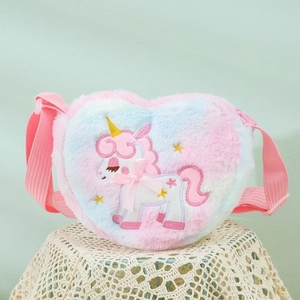 Detail of plush heart-shaped crossbody bag featuring unicorn embroidery and gradient fur