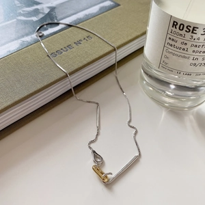 Detail of 925 silver box chain with gold and silver interlocking ring pendants