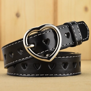 Black leather belt with silver heart buckle and hollowed heart patterns on wooden surface