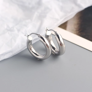 Macro shot of polished S925 sterling silver thick hoop earrings with a glossy metal finish