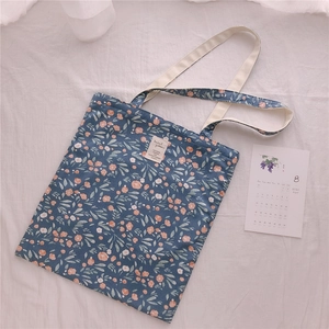 Macro detail of floral pattern on cotton tote bag with a minimalist woven label