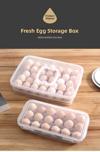Close-up of double-layer transparent egg storage box with handle on wooden table