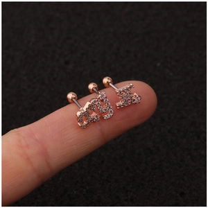 Rose gold alphabet ear studs with micro-paved zircons shown on fingertips