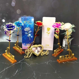 Macro shot of 24K gold foil colorful roses with golden Love display stand and gift box