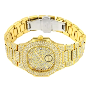 Macro detail of iced-out gold watch showing crystal dial and stainless steel clasp