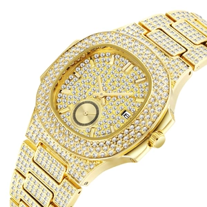 Close-up of golden full diamond iced out quartz watch with octagonal bezel and date display