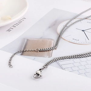 Minimalist double layer silver box chain necklace with lobster clasp in a flat lay view